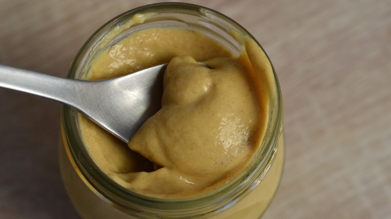 spoon in mustard jar