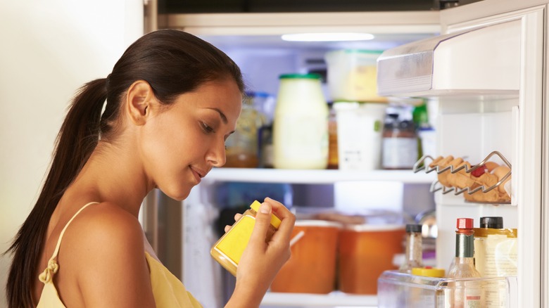 woman holding mustard bottle