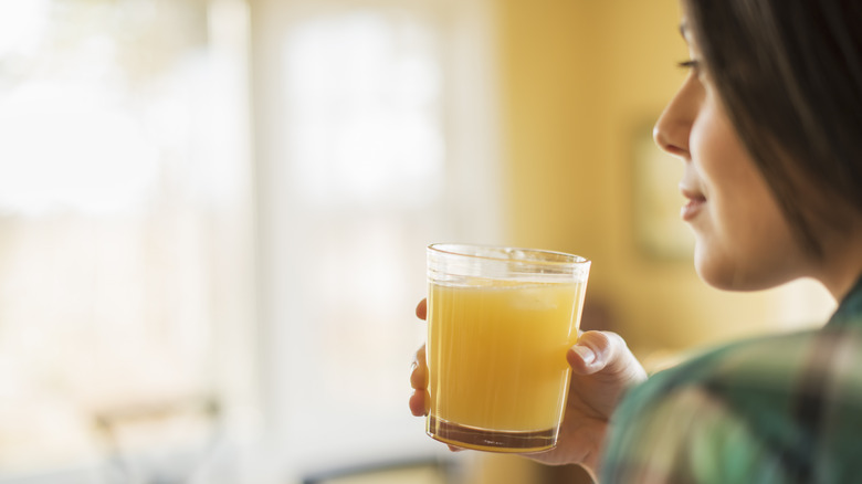 person profile drinking orange juice