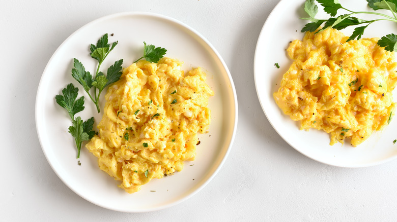 Scrambled eggs on white plates