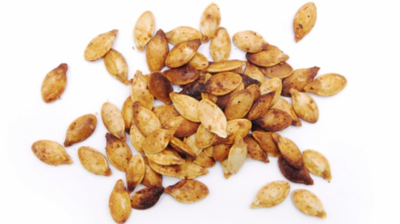 Roasted pumpkin seeds, white background