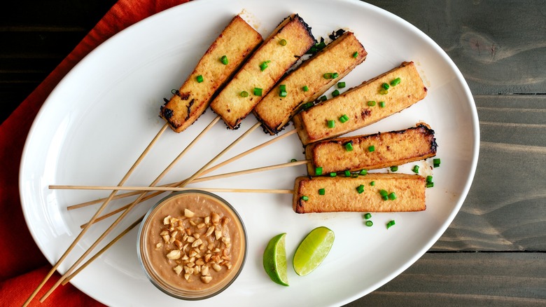 Tofu satay on white plate