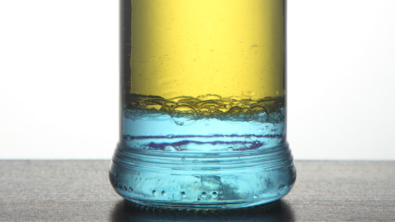 glass jar with oil and water separated