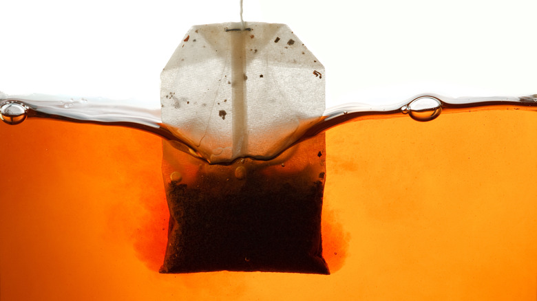 close up of teabag steeping in water