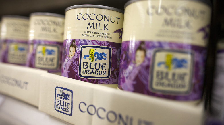 Cans of coconut milk on a shelf