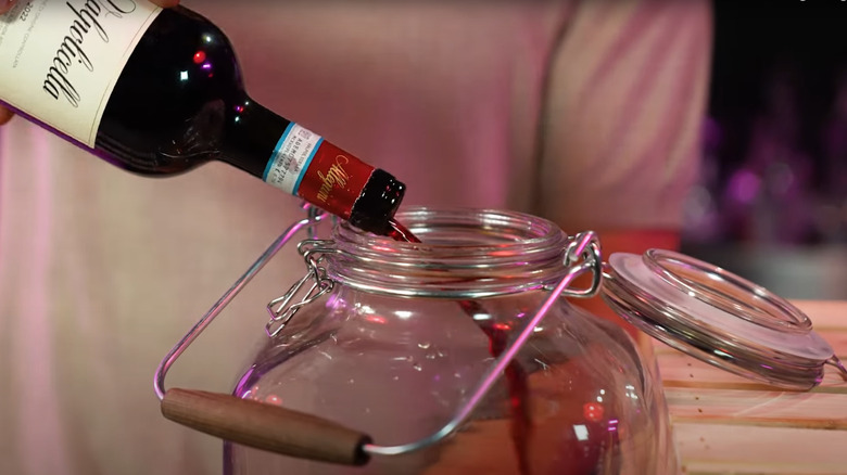 wine being poured into jar