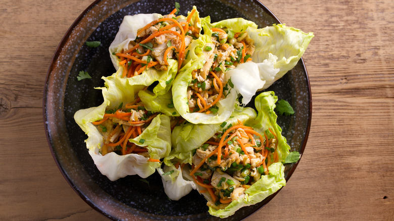 chicken lettuce wraps with carrots on plate