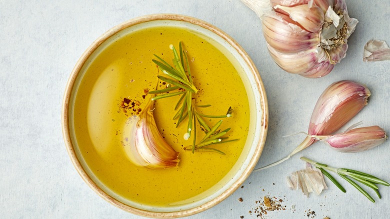 garlic clove in oil with rosemary 