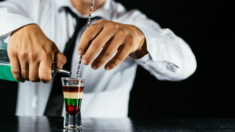 Bartender pouring a layered shot