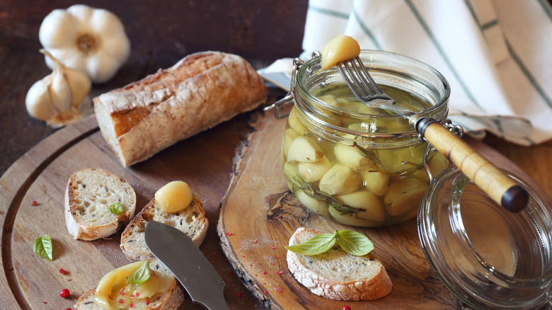 garlic confit in jar with baguette spread