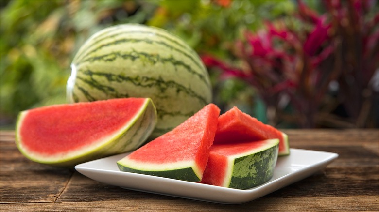 Watermelon slices covered in plastic wrap