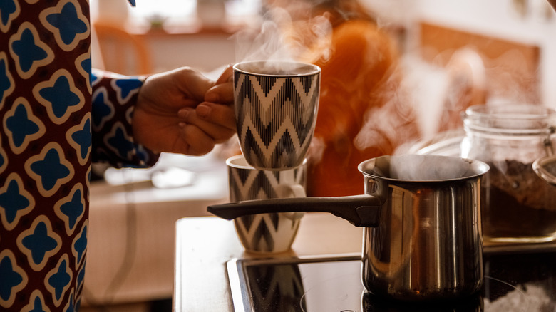 Woman making coffee on the stove