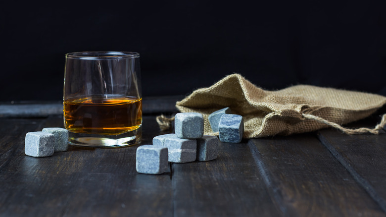 Whiskey in a glass with stones and burlap bag