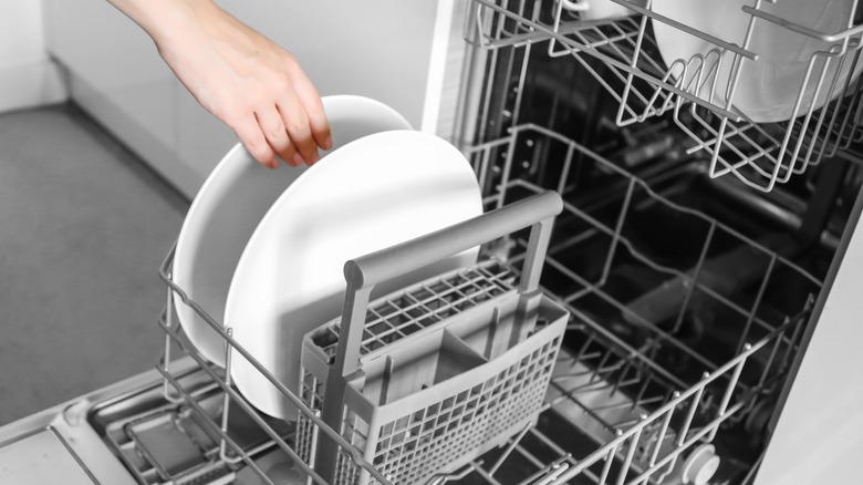 open dishwasher being loaded