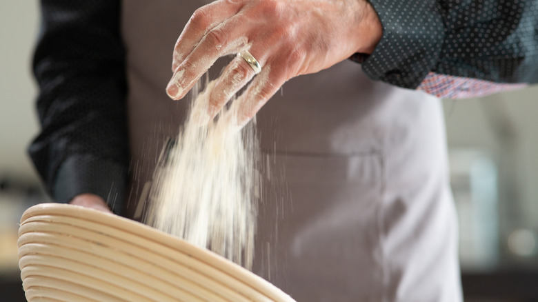 Baker seasoning a banneton basket