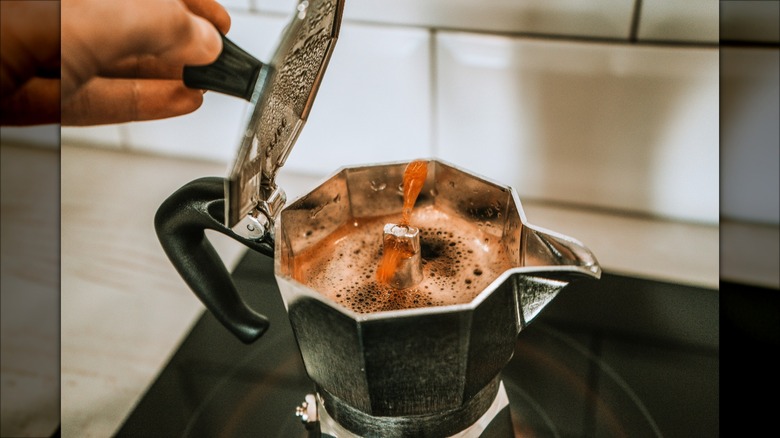 Open moka pot with leftover coffee