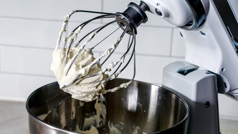 whisking whipped cream in a bowl on a stand mixer