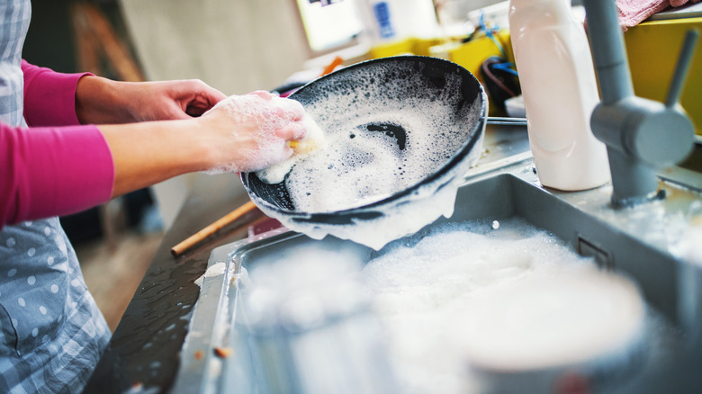 Woman washing a pan