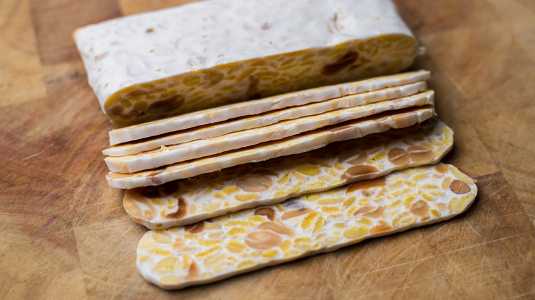 Tempeh sliced on wooden board