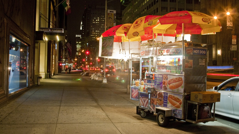 NYC hot dog cart at night