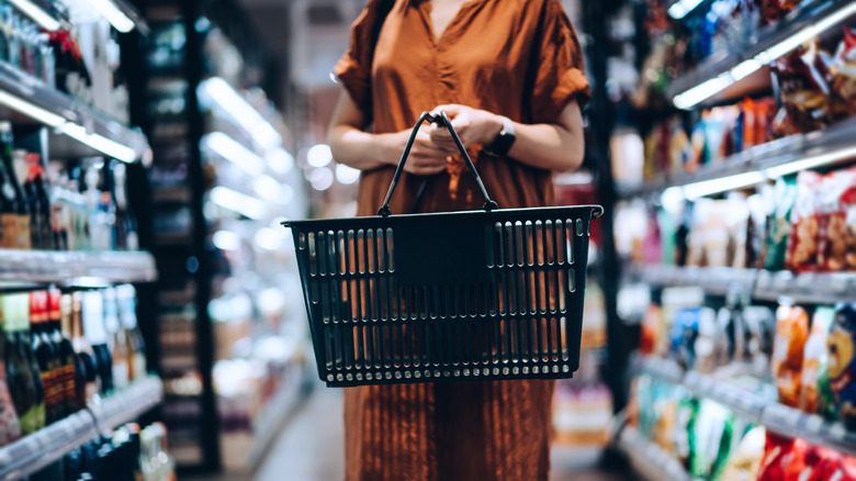 person with shopping basket grocery store