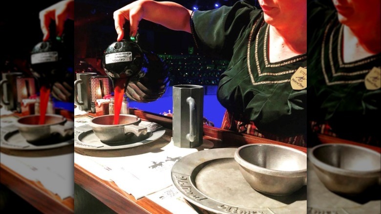 Medieval Times worker serving dish 