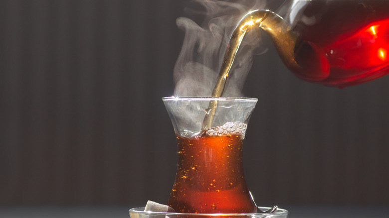 black tea being poured into a glass