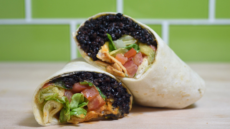 Black bean loaded burrito cut in half