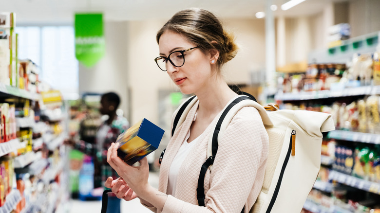 woman reading food label