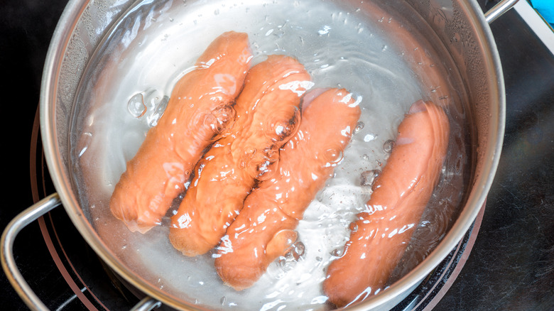 Frankfurters boiling in a pan