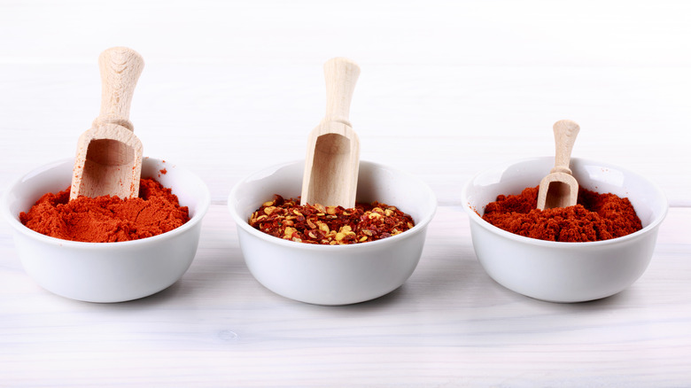 Three bowls of red spices