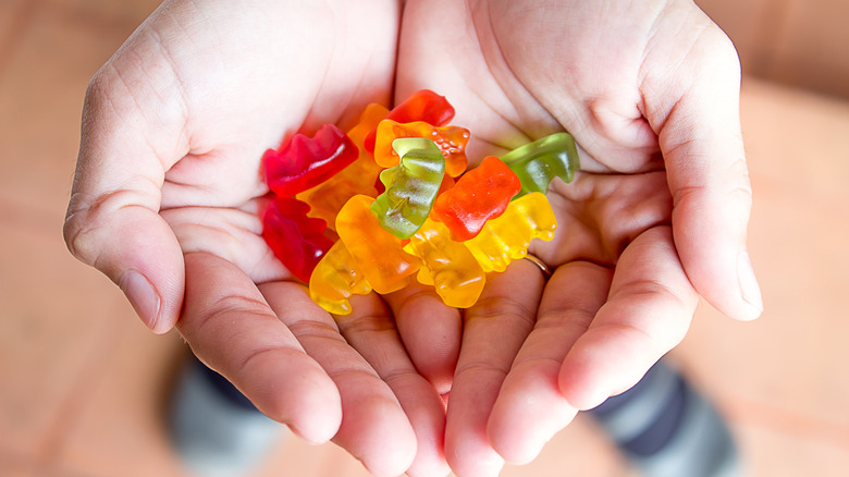 Hands full of gummy bears