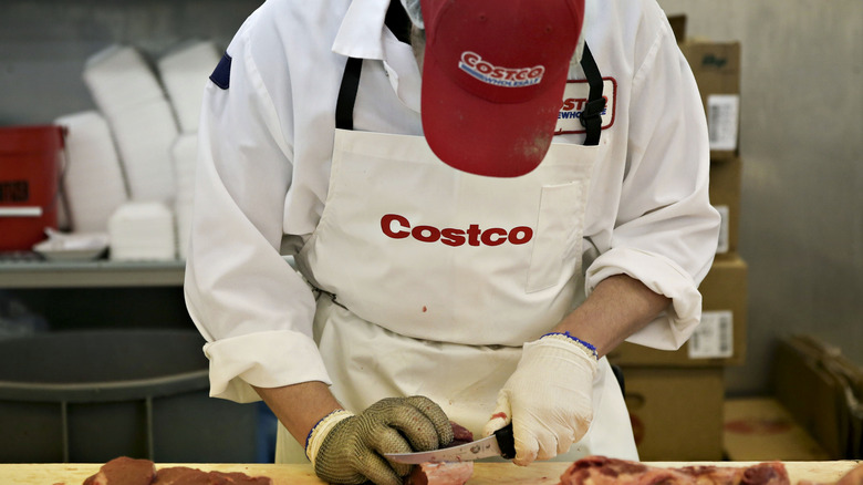 a costco butcher cutting meat