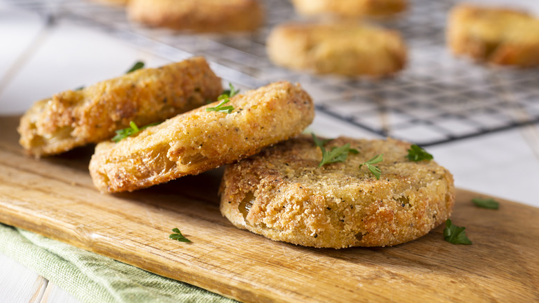 Fried green tomatoes on a wooden board