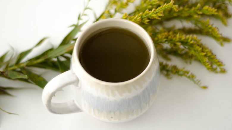 Mug holding goldenrod herb tea