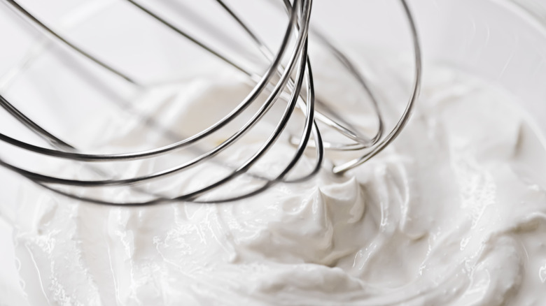 Whipped cream and whisk