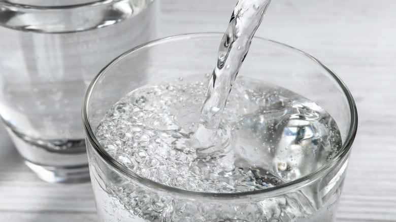 Pouring club soda into glass