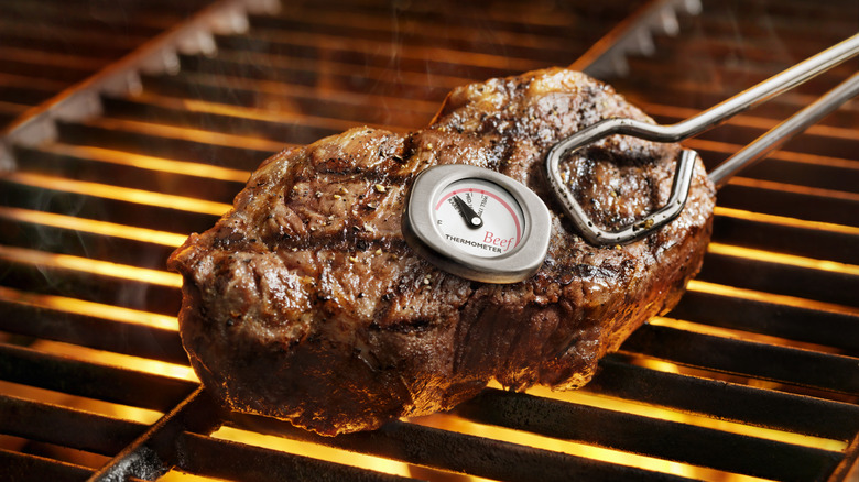 Thermometer measuring grilled steak temperature