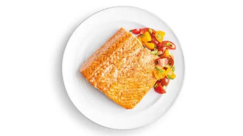 Pan fried salmon and tomatoes on a plate