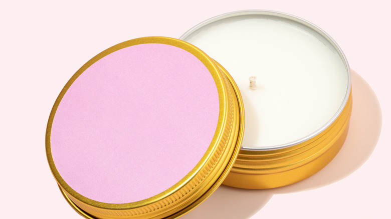 pink and white candles in gold tins