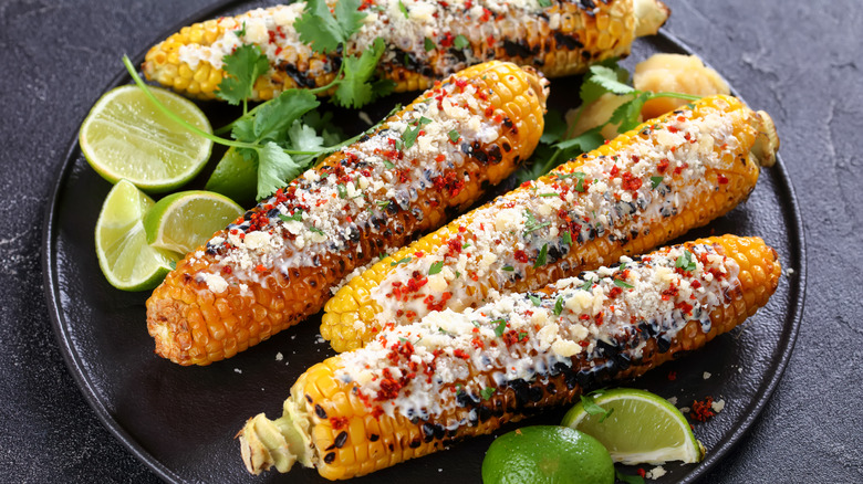 Plate of elote corn cobs and limes