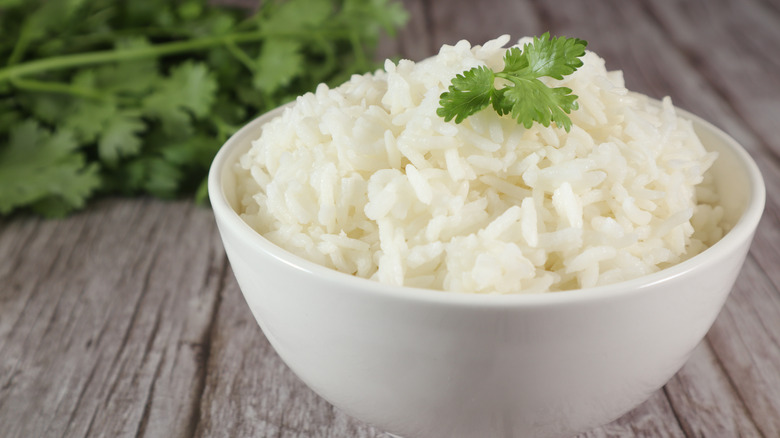 Bowl of white rice with parsley sprig