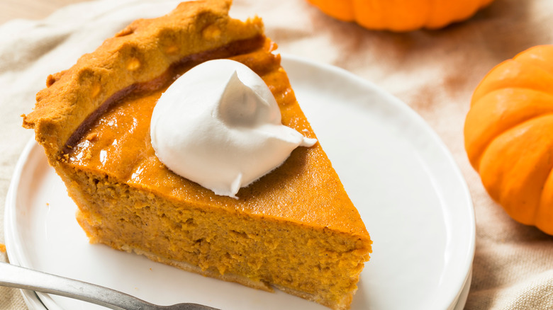 slice of pumpkin pie with whipped cream