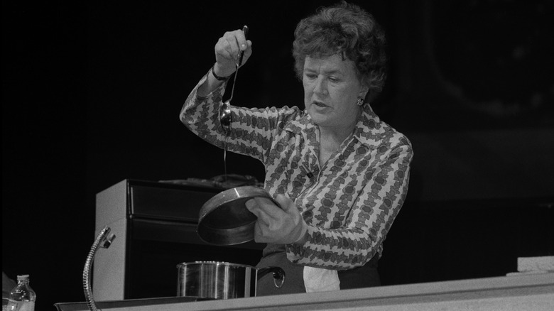 Julia Child cooks in front of an audience 