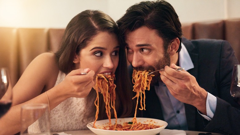 Couple eating spaghetti