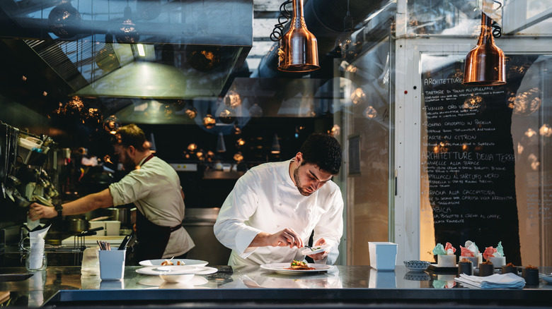 chefs working at different kitchen stations