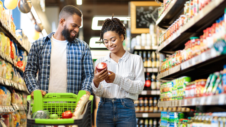 Two people grocery shopping