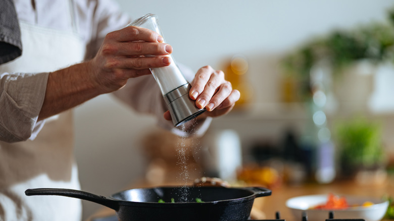 Salting stew on stove