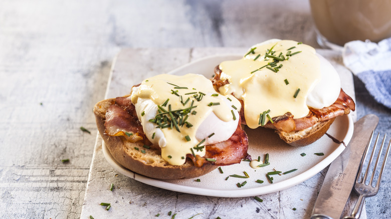 two pieces of Eggs Benedict on a plate