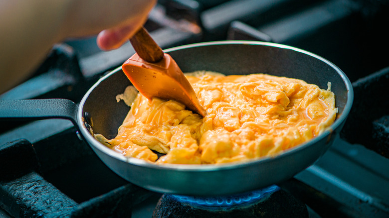 cooking scrambled eggs in pan